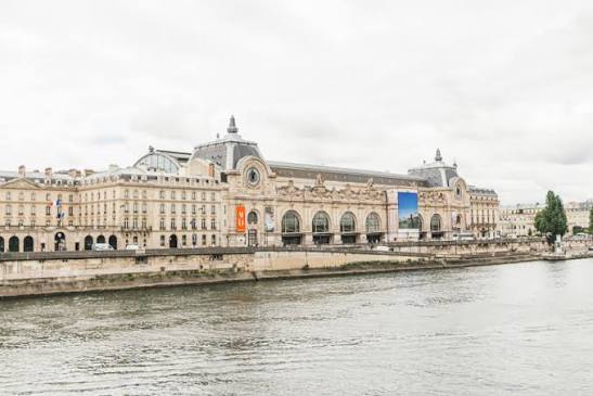 Musée d'Orsay au bord de la Seine sous un ciel nuageux